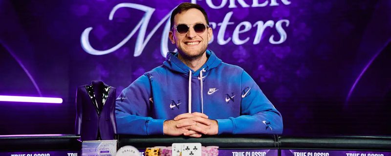 Joey Weissman smiling at the Poker Masters final table with his chips, the winning eight of clubs and the purple jacket trophy